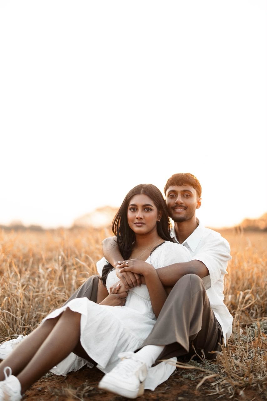 Zivan and Amelia sitting together in a golden field